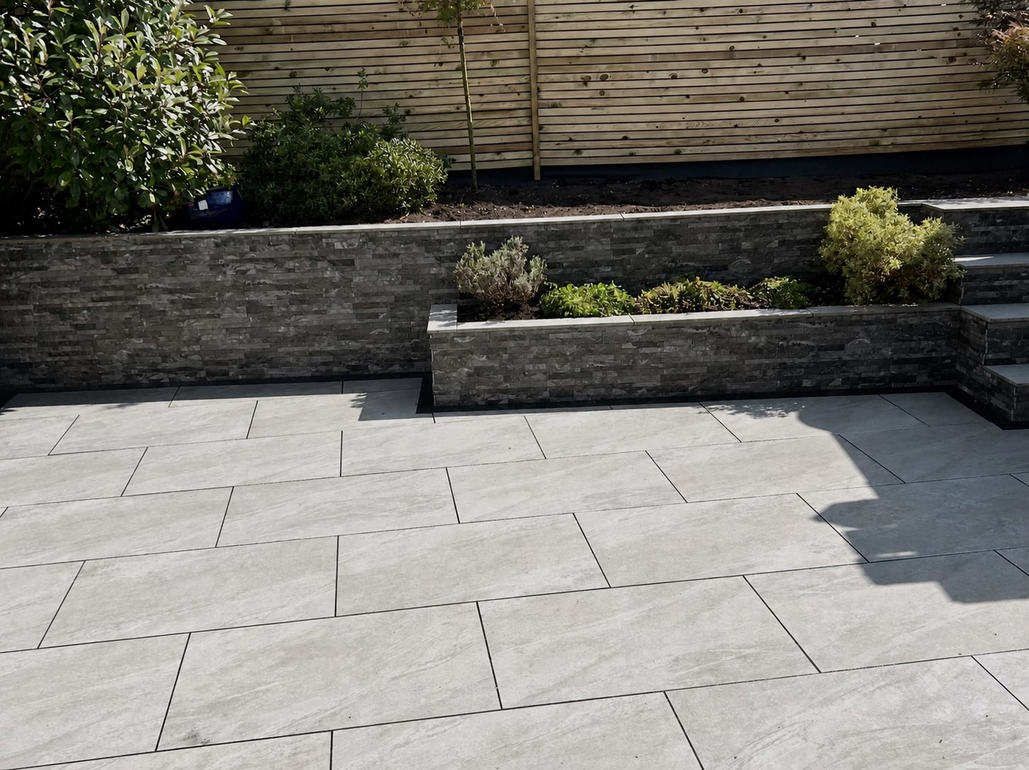 Paving beside raised timber planting beds