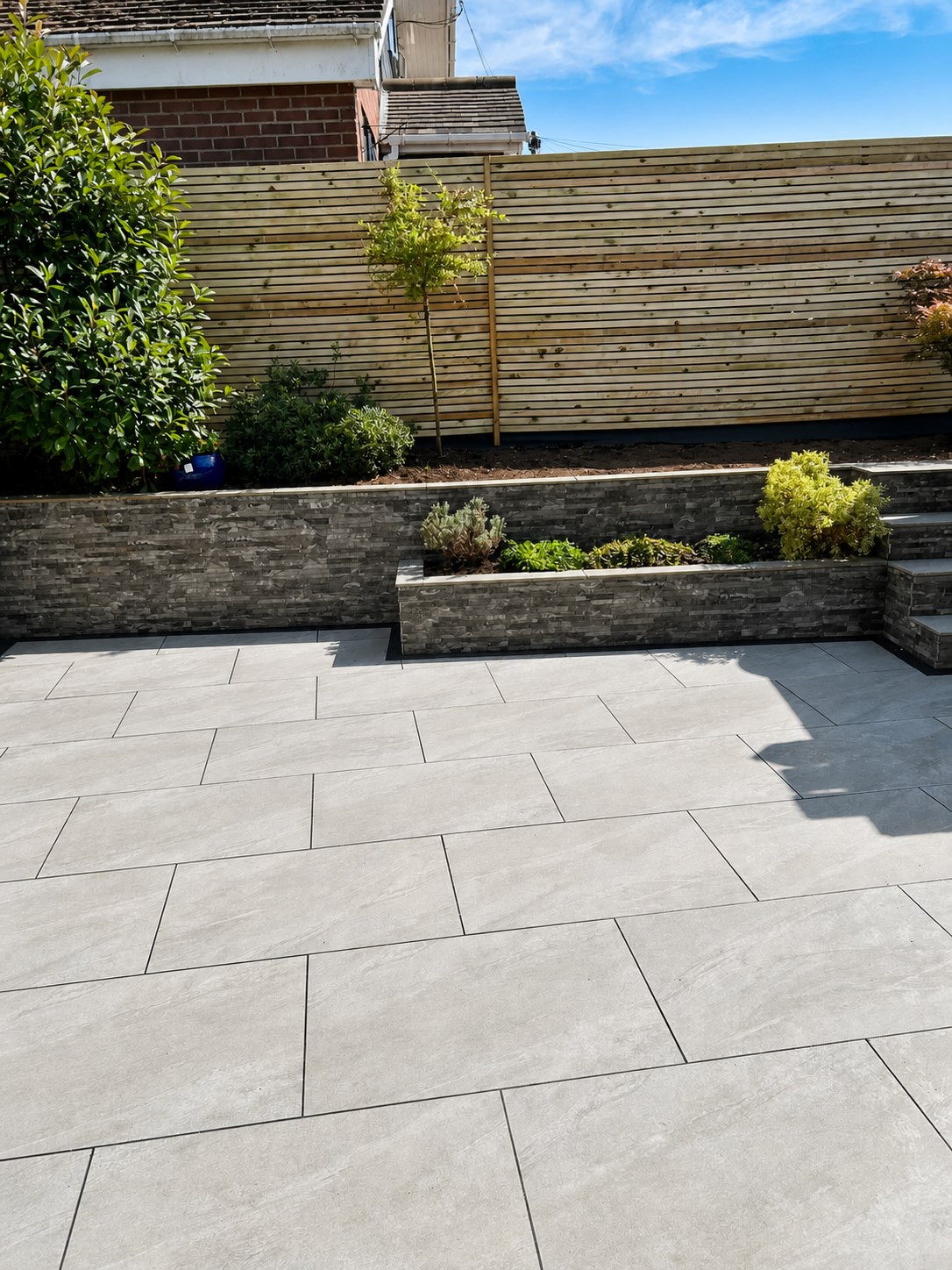 Paved patio with curved lawn edge